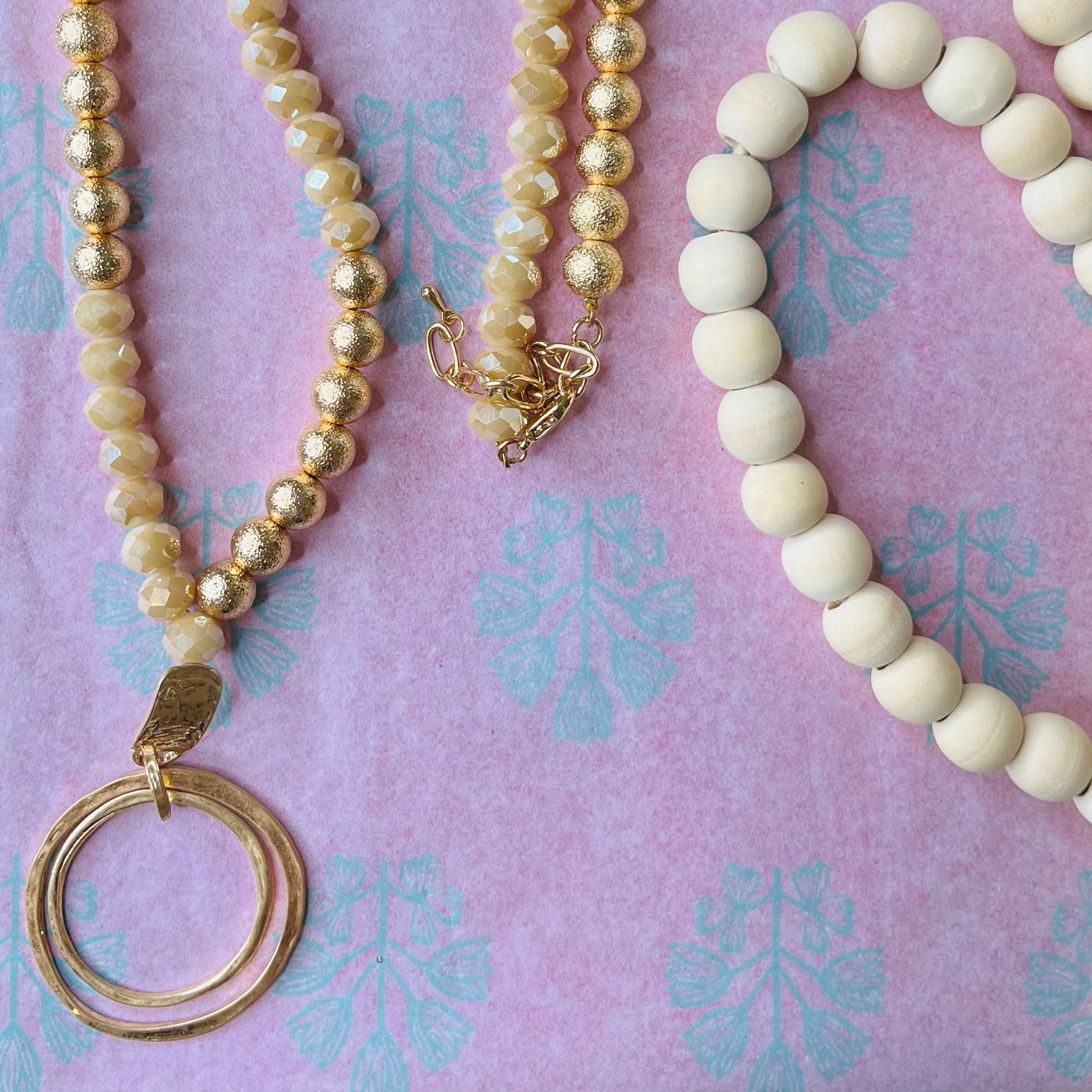 long beaded gold necklace with pendant